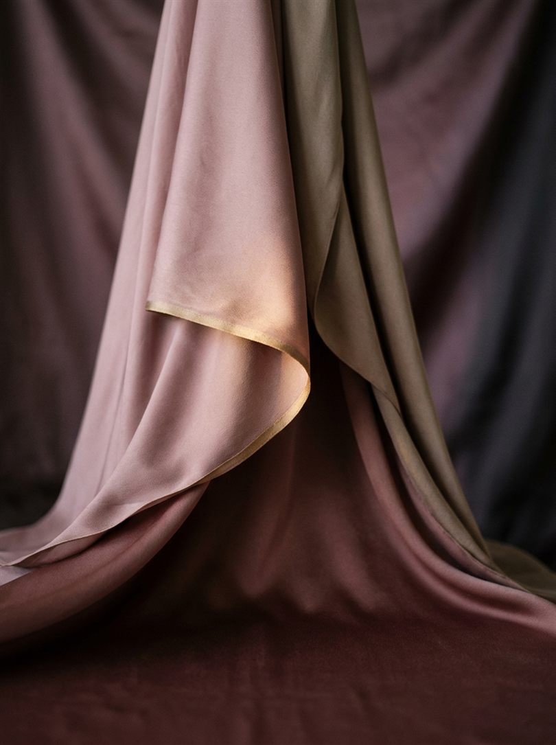 Draped silk in dusty rose and gold, the studio's palette